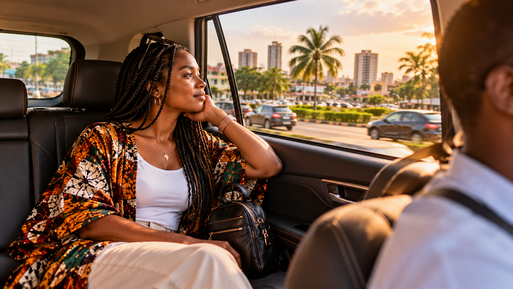 Ghanaian woman travelling through Accra in a private car, looking out the window at vibrant city streets and tropical greenery in warm late-afternoon light.
